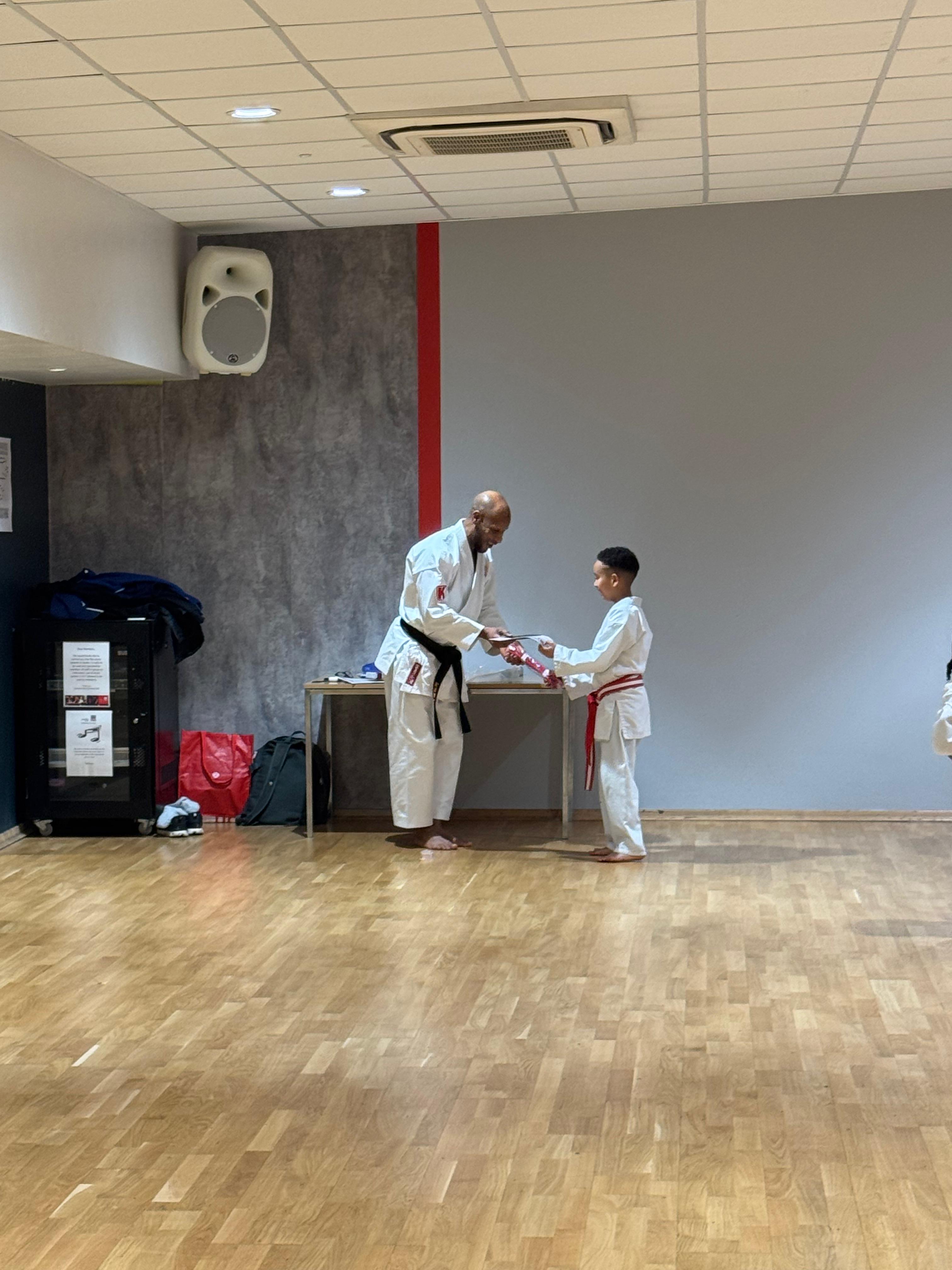 AN Shotokan Karate grading day ceremony with students receiving belts