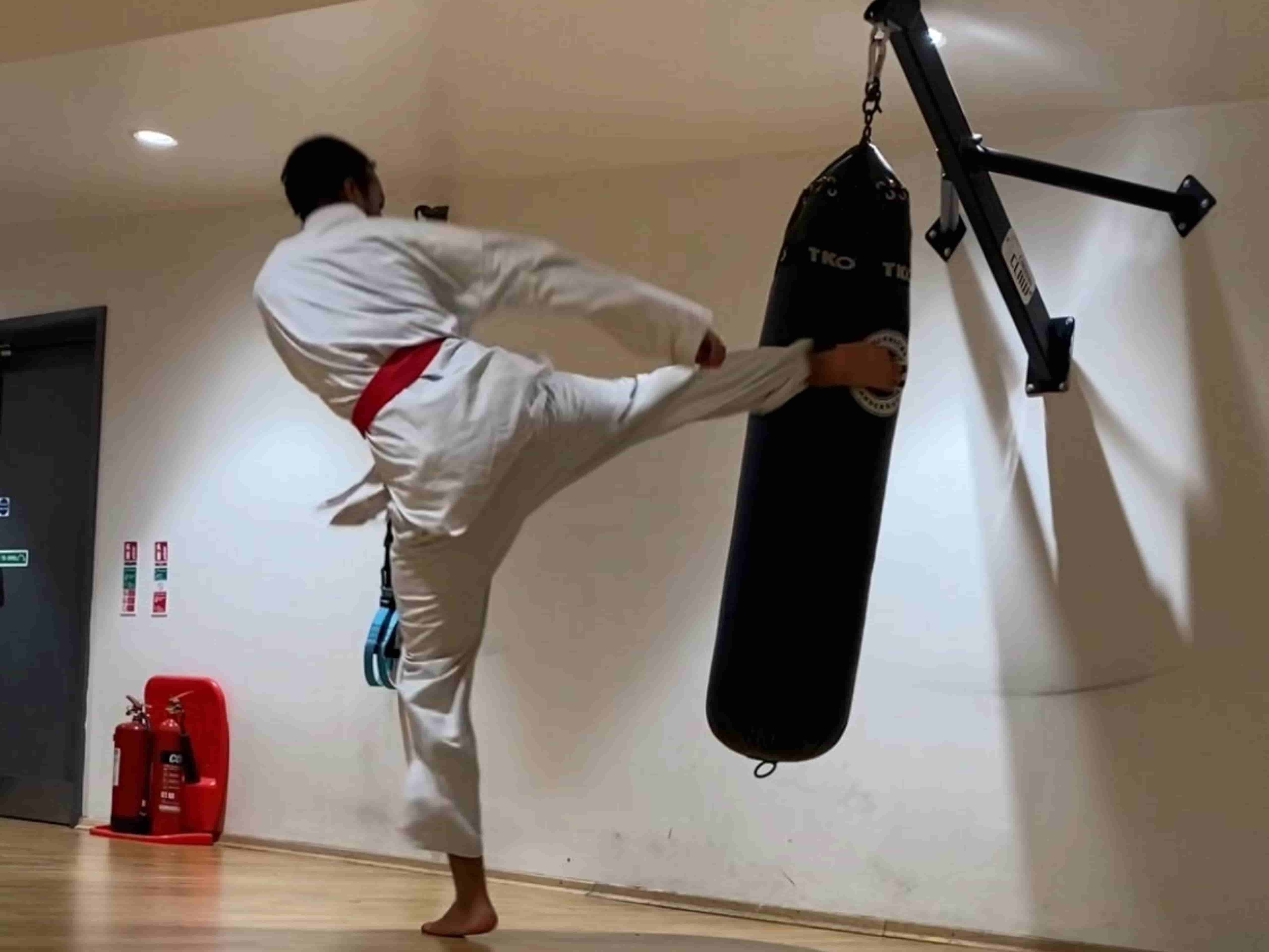 Students practicing Shotokan karate blocks in London dojo